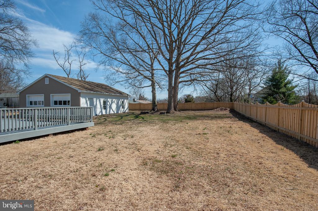6525 Joyce Road Alexandria, VA 22310 - Photo 49 of 51 a backyard of a house with large trees and wooden fence