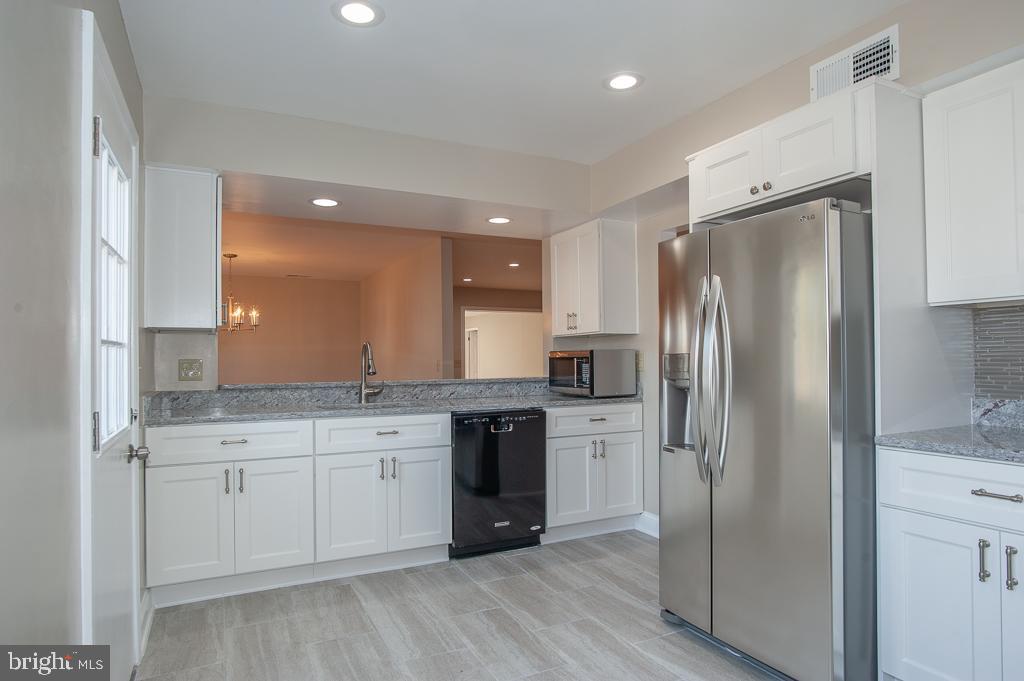 6525 Joyce Road Alexandria, VA 22310 - Photo 9 of 51 a large kitchen with stainless steel appliances granite countertop a refrigerator and a sink