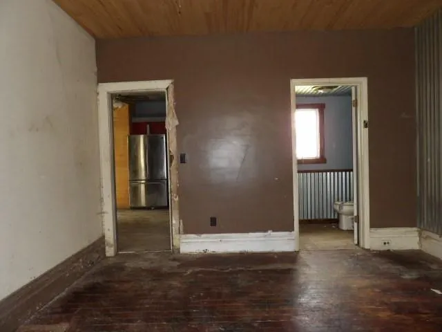 a view of wooden floor and windows in a room