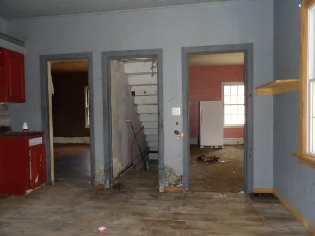 a view of a livingroom with an empty space and a window