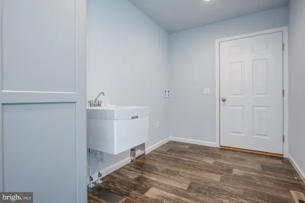 a view of a room with wooden floor
