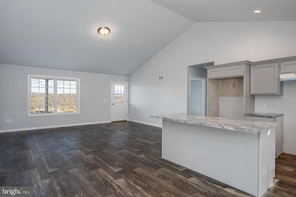 an empty room with windows and entrance