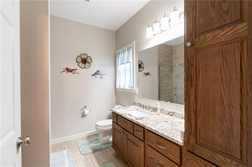 145 Duncan Road Harrisville, PA 16038 - Photo 28 of 46 a bathroom with a granite countertop sink a toilet and shower