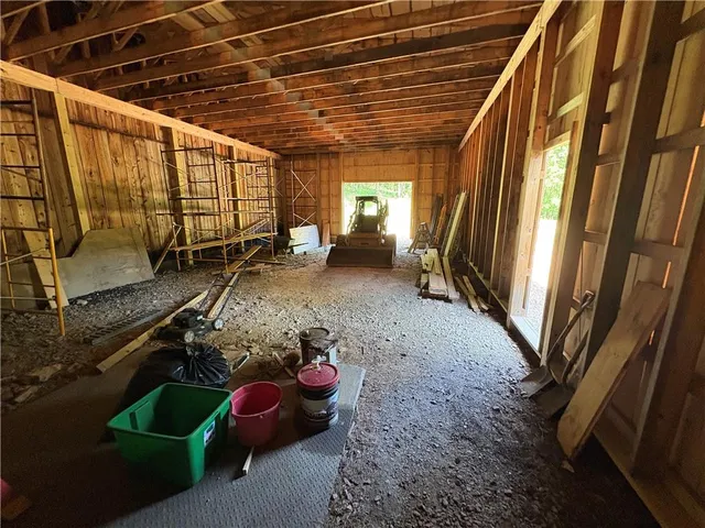 a room with lots of trees and furniture
