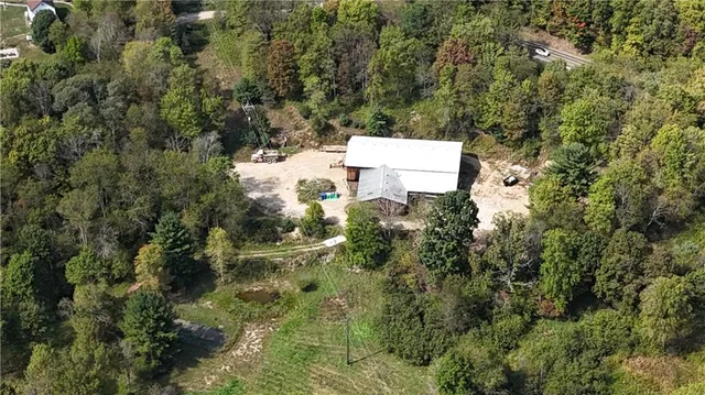 an aerial view of a house with yard