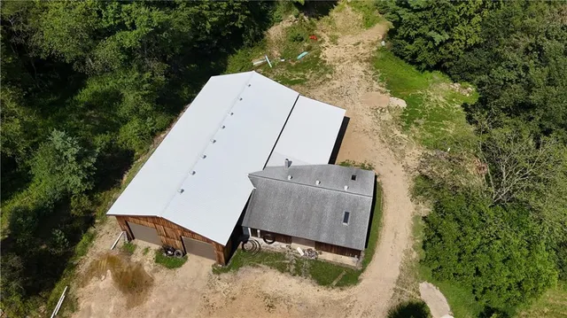 an aerial view of a house with pool table and chairs