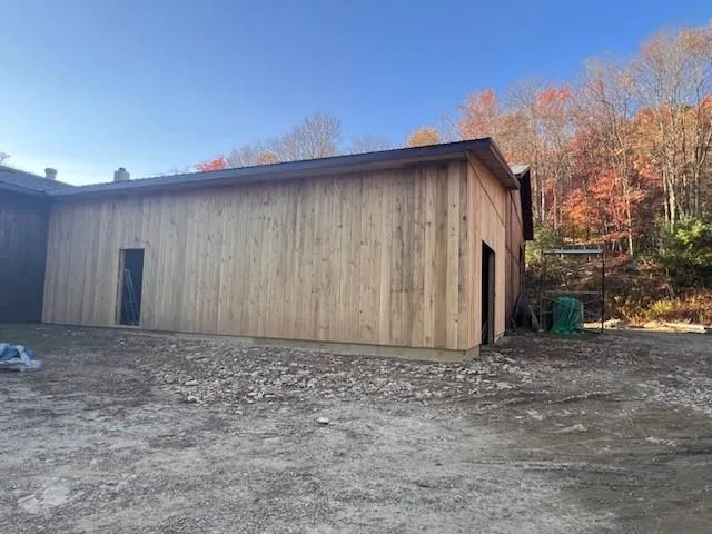 a view of a house with a wooden fence