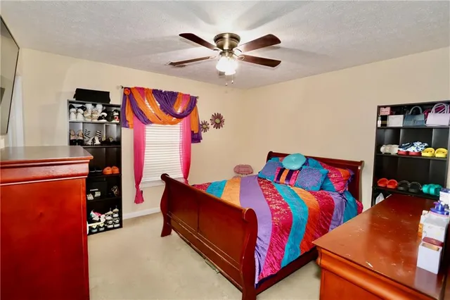 a living room with furniture a chandelier and a flat screen tv