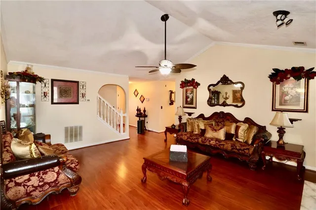 a living room with furniture window and wooden floor