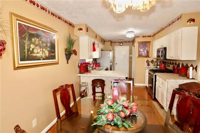 a very nice looking dining room with furniture and a chandelier