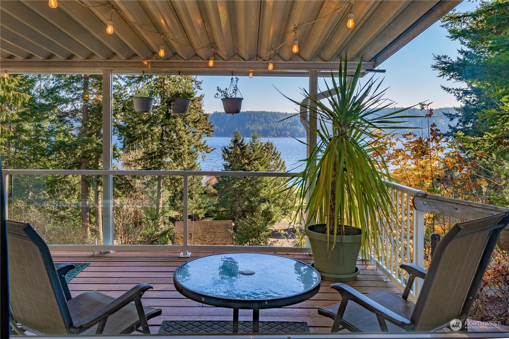 9320 Northeast North Shore Road Belfair, WA 98528 - Photo 16 of 40 a view of a balcony with a table and chairs