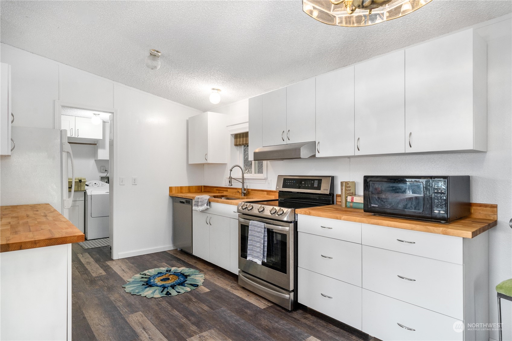 9320 Northeast North Shore Road Belfair, WA 98528 - Photo 20 of 40 a kitchen with granite countertop white cabinets and white appliances