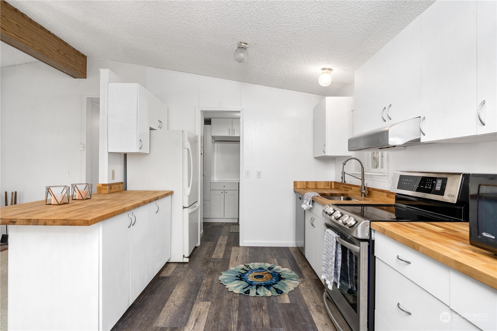 9320 Northeast North Shore Road Belfair, WA 98528 - Photo 21 of 40 a kitchen with stainless steel appliances granite countertop a sink stove and refrigerator