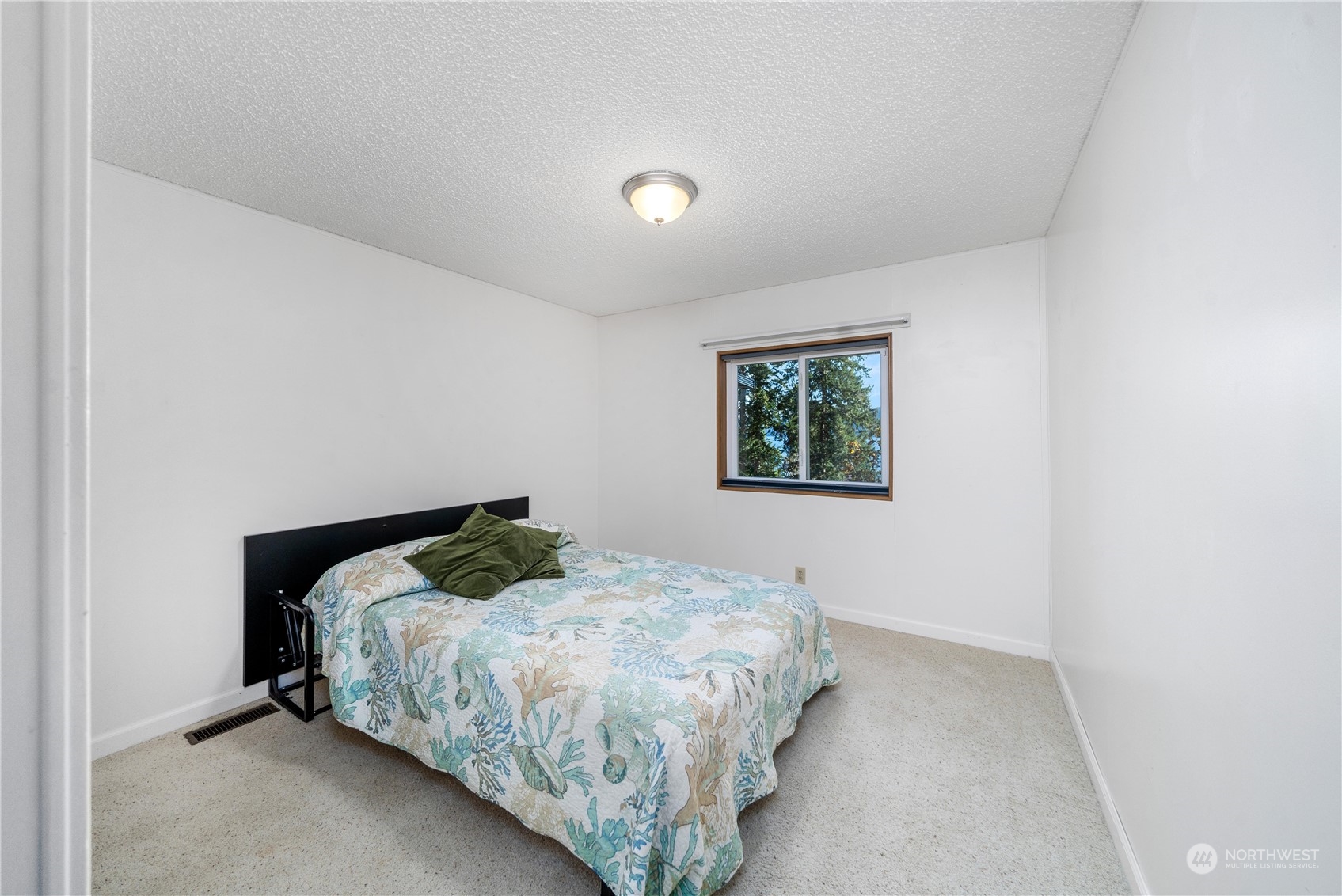9320 Northeast North Shore Road Belfair, WA 98528 - Photo 33 of 40 a bedroom with a bed and a window