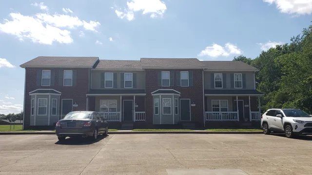 a car parked in front of a brick house