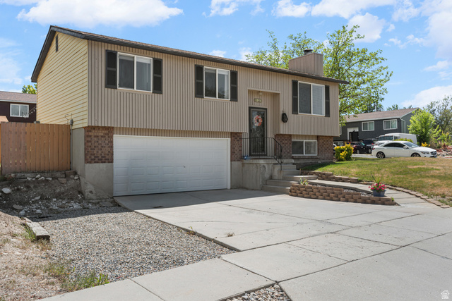 3951 Brixton Road Salt Lake City, UT 84129 - Photo 4 of 22 Split-level residence featuring a two-tone facade with beige siding and brick accents