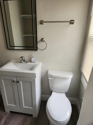 a white toilet sitting next to a bathroom sink