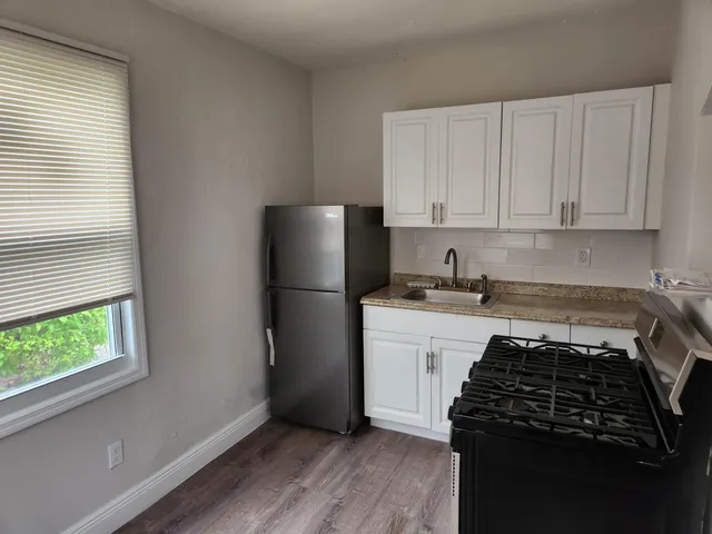 a kitchen with a refrigerator stove and cabinets