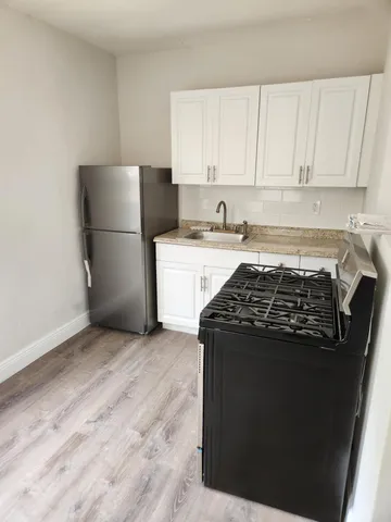 a kitchen with a stove and a refrigerator