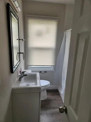 a bathroom with a sink toilet and mirror