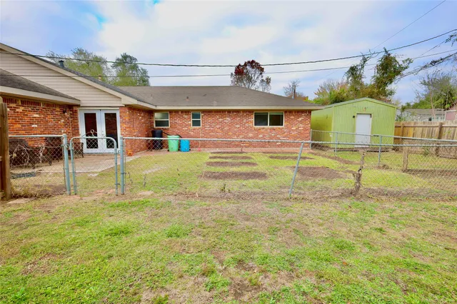 a view of a big house with a big yard and large tree