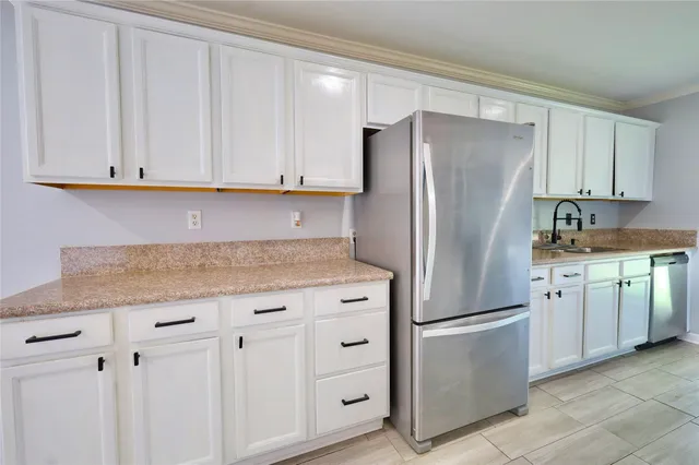 a kitchen with granite countertop cabinets and steel stainless steel appliances