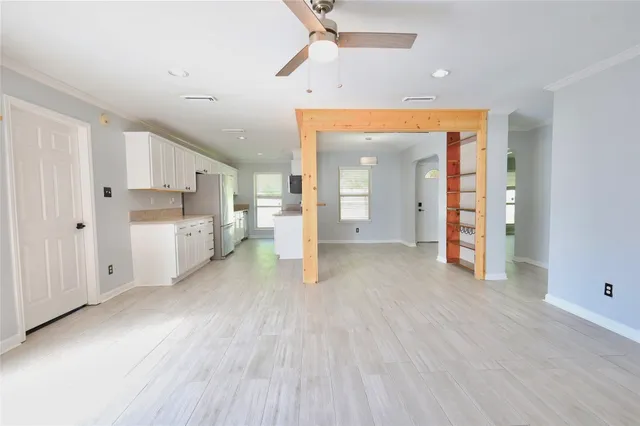 a view of a kitchen with a sink and a refrigerator