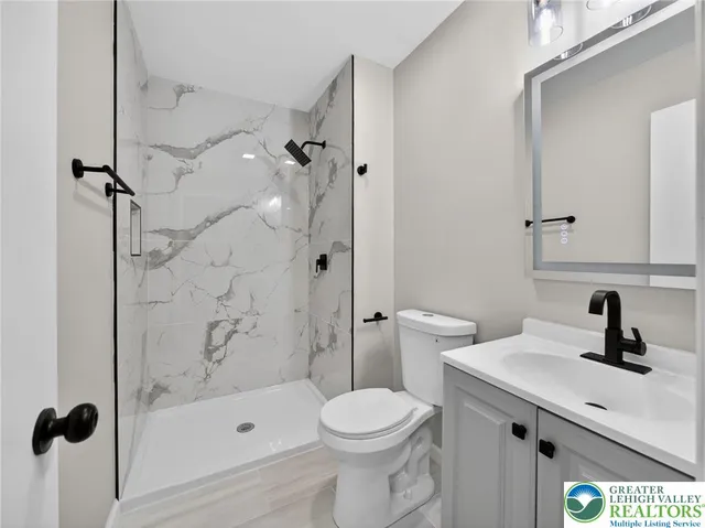 a bathroom with a sink toilet and shower