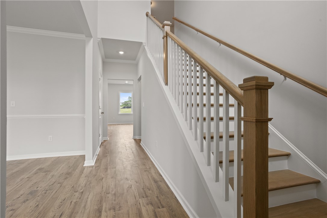 555 Hydrangea Street, Unit LOT 47 Seneca, SC 29678 - Photo 7 of 38 A grand staircase with natural wood accents provides a captivating focal point upon entry.