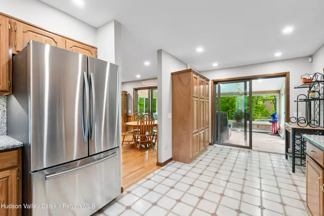 a kitchen with stainless steel appliances granite countertop a refrigerator and a sink
