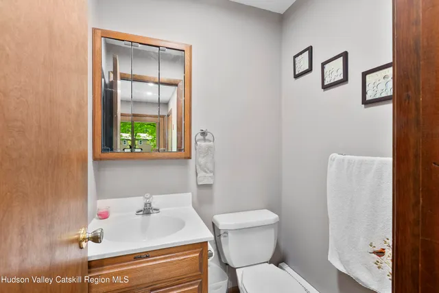 a bathroom with a sink toilet and mirror