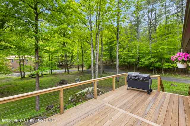 a view of a deck with chair and tables
