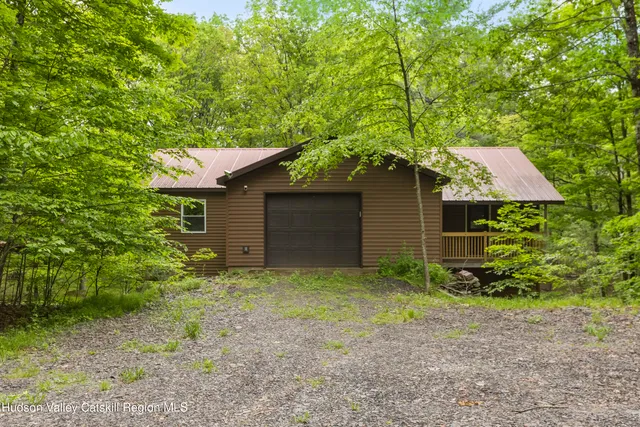 a view of a house with a yard and a fountain