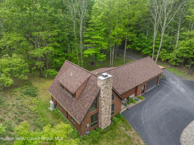 an aerial view of a house with garden space and street view
