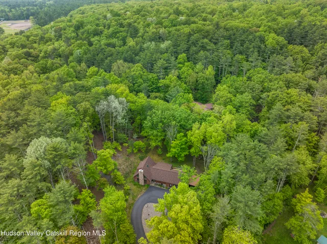 a view of a house with a yard and a fountain