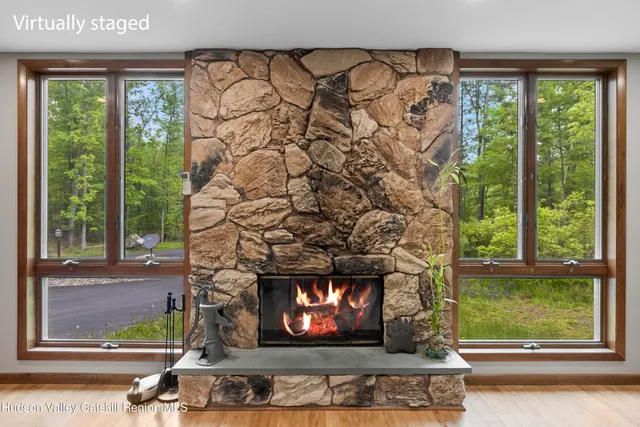 a living room with a fireplace and a window