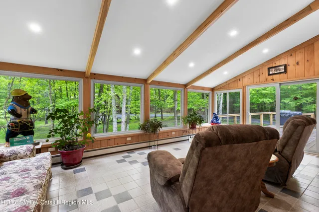 a living room with furniture and garden view
