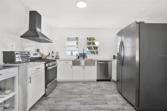 a kitchen with a sink stainless steel appliances and cabinets