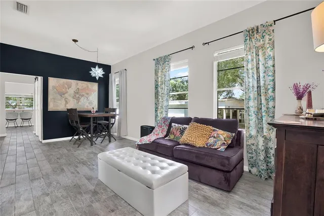 a living room with furniture and large windows