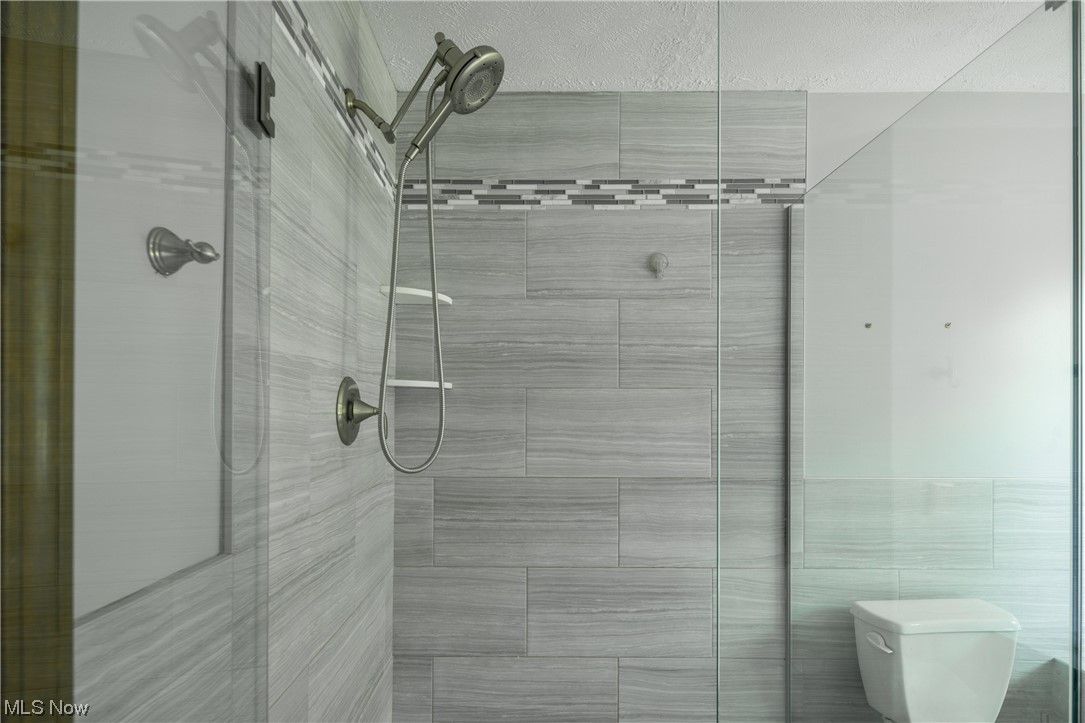 868 Trebisky Road Cleveland, OH 44121 - Photo 20 of 35 Bathroom with tile walls and tile walk in shower