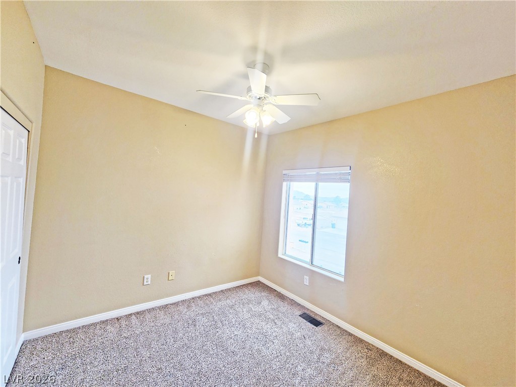 1421 Star Road, Unit 2 Pahrump, NV 89048 - Photo 22 of 33 Spare room with visible vents, carpet flooring, baseboards, and ceiling fan