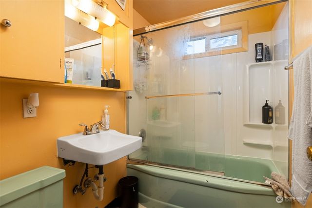 a bathroom with a sink a mirror and a shower