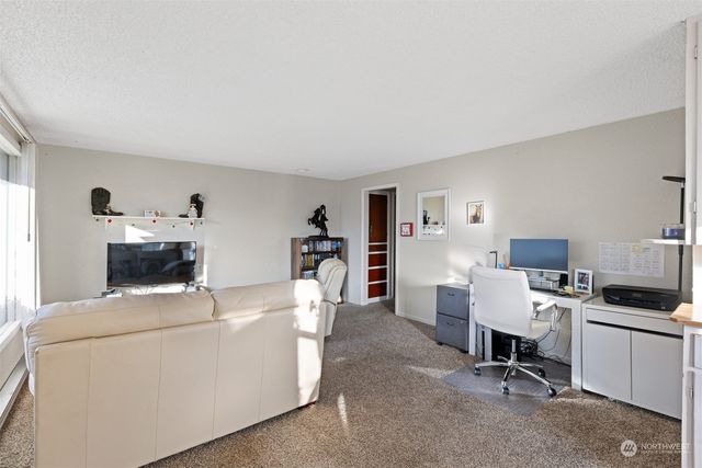 a view of living room with furniture and workspace
