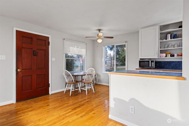 a view of a dining room with furniture window and wooden floor
