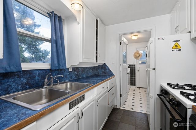 a kitchen that has a sink and a stove