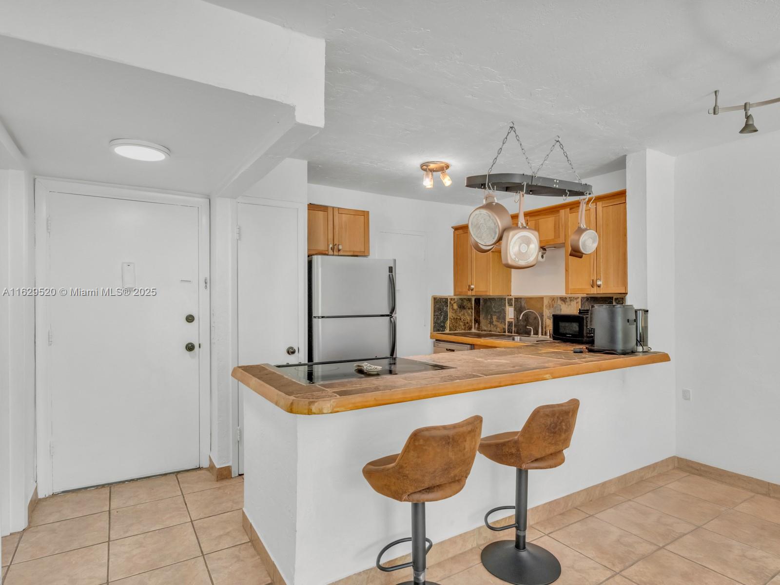 7403 Southwest 82nd Street, Unit 201N Miami, FL 33143 - Photo 11 of 43 a room with table and chairs