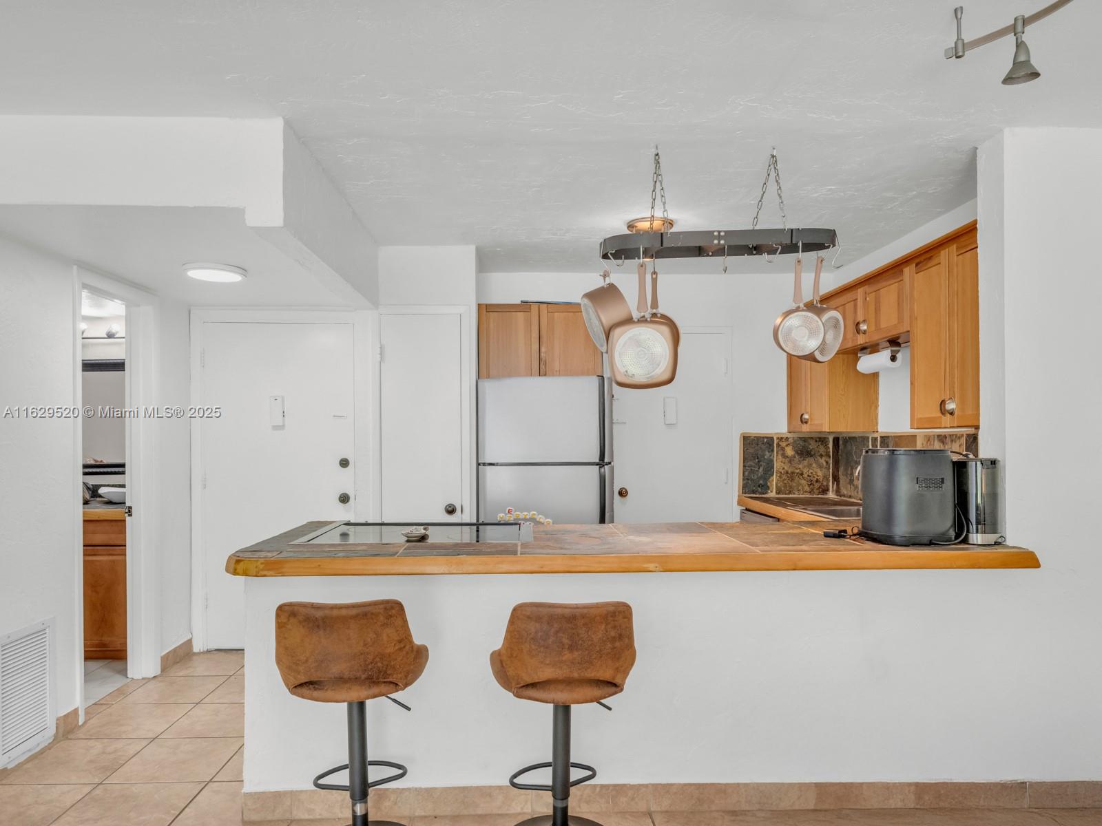 7403 Southwest 82nd Street, Unit 201N Miami, FL 33143 - Photo 12 of 43 a kitchen with stainless steel appliances granite countertop a sink and a refrigerator
