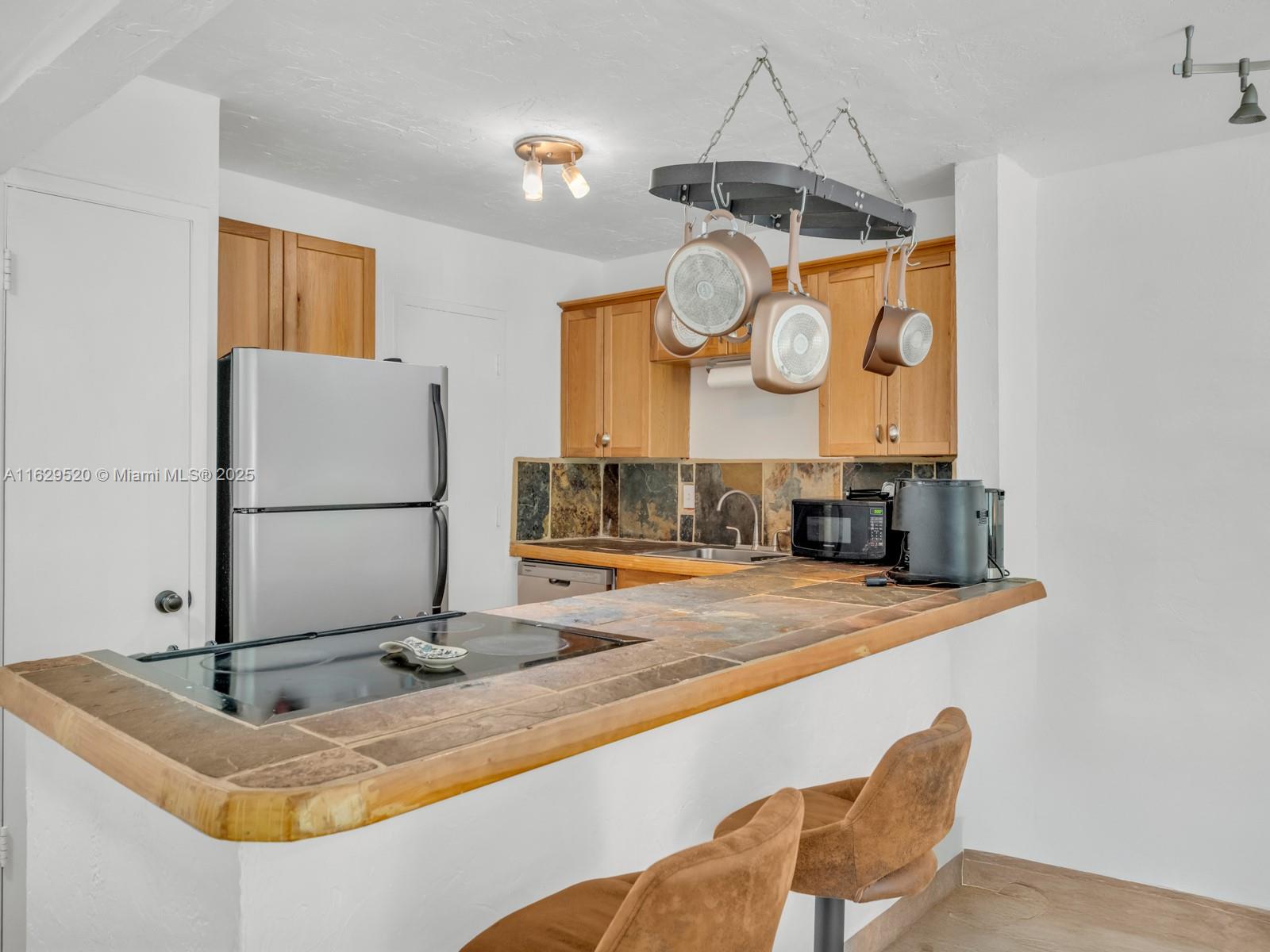 7403 Southwest 82nd Street, Unit 201N Miami, FL 33143 - Photo 14 of 43 a view of a kitchen with a sink and refrigerator