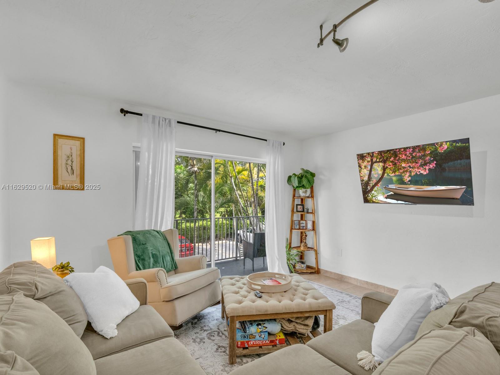 7403 Southwest 82nd Street, Unit 201N Miami, FL 33143 - Photo 18 of 43 a living room with furniture and a large window
