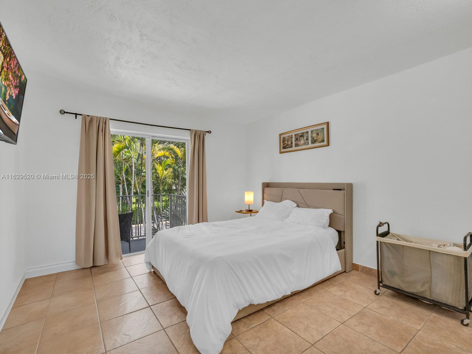 7403 Southwest 82nd Street, Unit 201N Miami, FL 33143 - Photo 23 of 43 a bedroom with a bed and a window